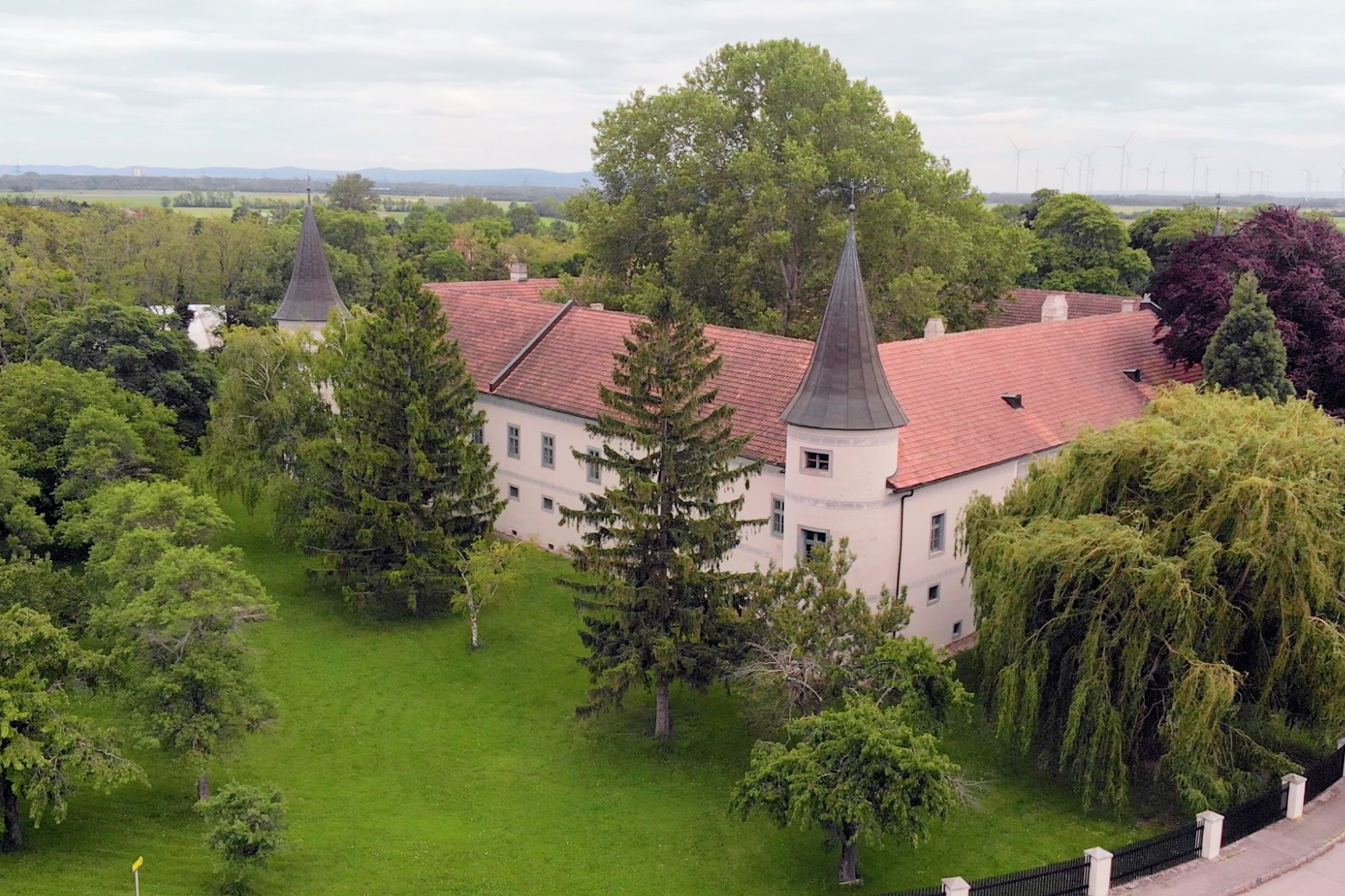 Aerial view of Schloss Trumau with both towers and the surrounding park