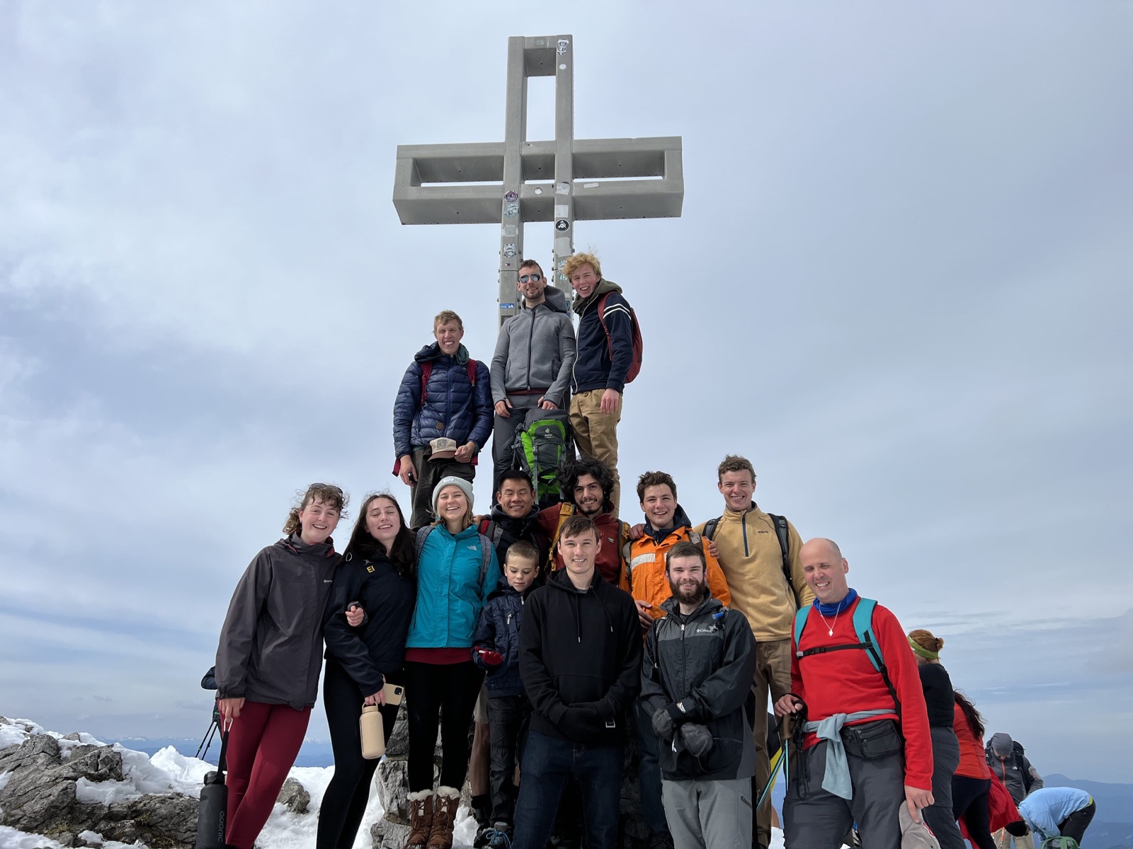 Students gathered around the summit cross on the Schneeberg