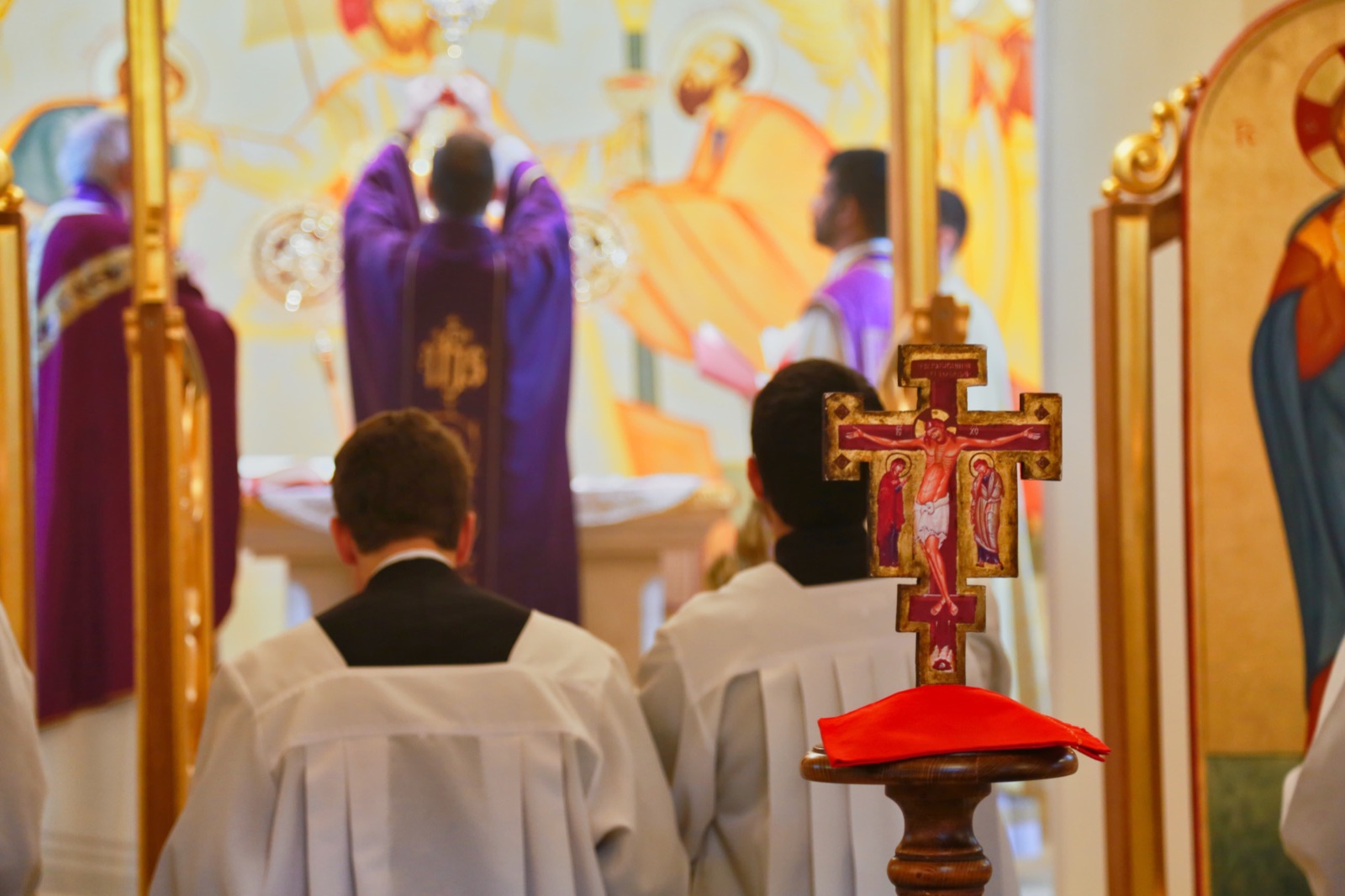 Byzantine Divine Liturgy seen past the red processional cross