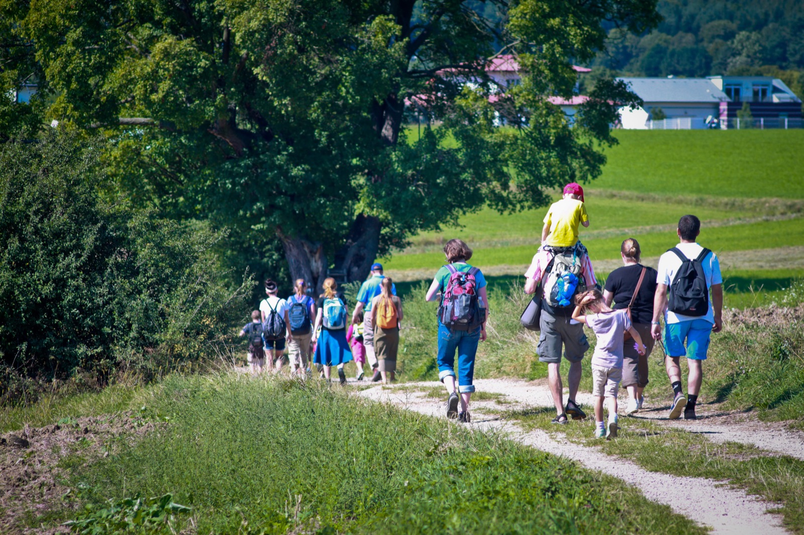 Pilgrims walking to Heiligenkreuz, a child on his father&rsquo;s shoulders