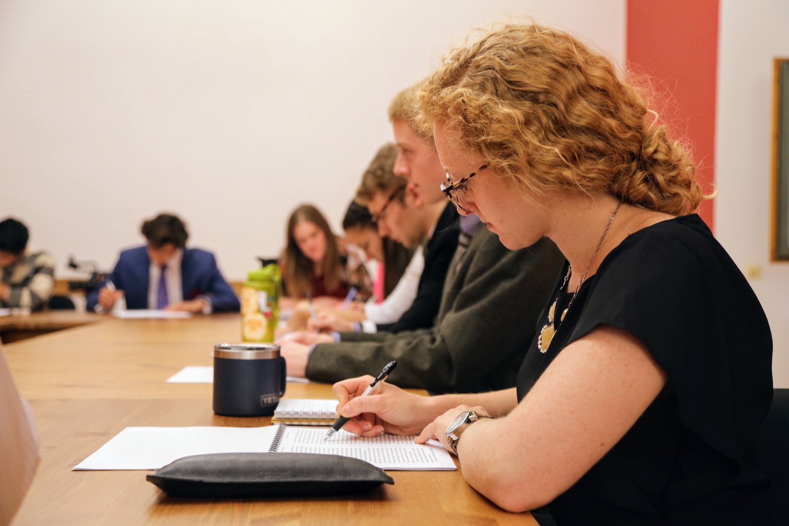 A student writing intently during seminar